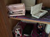 a small shelf with a laptop and other items on it