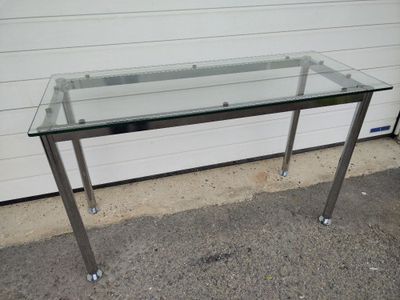 a glass table with a metal frame on it