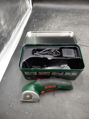 a green box with tools in it sitting on the floor