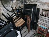 a lot of chairs that are stacked up in a room