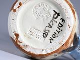 a close up of a cup on a white surface