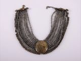 a close up of a necklace on a white surface