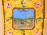 a yellow scarf with a picture of the kaabah mosque