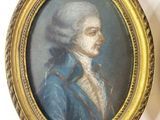 two framed pictures of a man in a blue coat