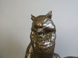 a statue of an owl that is sitting on top of a table