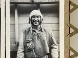 a black and white photo of a man in a pilot ' s uniform