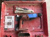 a red tool box with tools in it on the floor