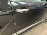 a black car that has a door handle on the side of it