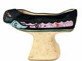 a black shoe with a pink and blue design on it