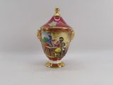 a small vase that has a painting on it