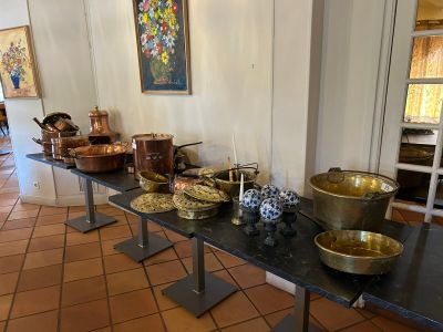 many bowls and pans on a table in a room