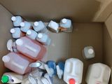 a cardboard box filled with bottles of milk and other items