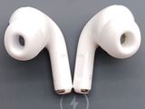 two white earphones sitting on top of a table next to each other