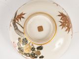 a white bowl with a gold rim and a flower design on it
