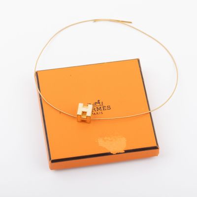 an orange box with a gold cross on it and a gold chain