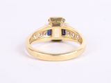 a yellow gold ring with blue sapphires and diamonds