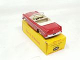 a red toy car sitting on top of a yellow box