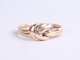 a close up of a gold ring on a white surface