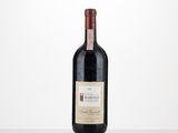 a bottle of red wine sitting on top of a table