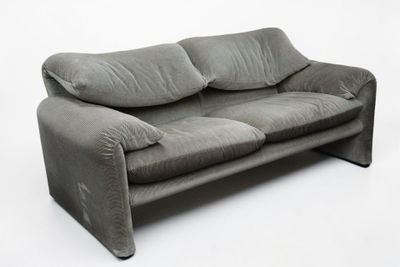 grey couch with pillows on it on a white background