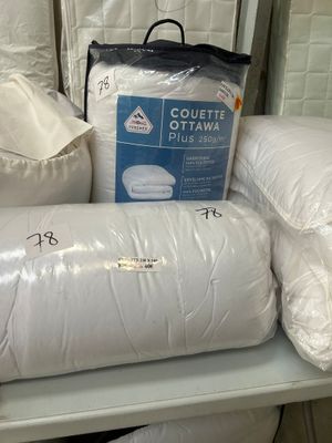 a pile of pillows on a shelf in a store