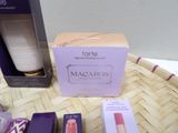 a box of macaron and a box of lipstick on a table
