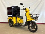 a yellow scooter with a black box on the back of it