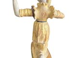 a figurine of a boy holding a baseball bat