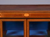 an old wooden table with two glass doors on top of it