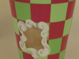 a green and red cup with a hole in it