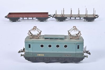 three toy trains on a white surface with one train on the other