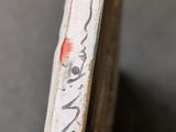 a close up of a piece of wood with writing on it