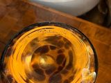 a jar of liquid sitting on a table next to a blender