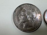 two coins that are sitting side by side on a table