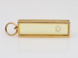 an 18k yellow gold pendant with a diamond