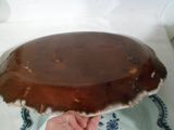 a person holding a chocolate cake on a plate