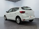 the rear end of a white car in a white room