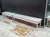 two benches sitting next to each other on a tiled floor