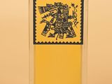 a close up of a bottle of perfume on a yellow background