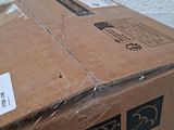 a box that is sitting on a table with some stickers on it
