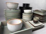 a lot of plates and bowls sitting on a table