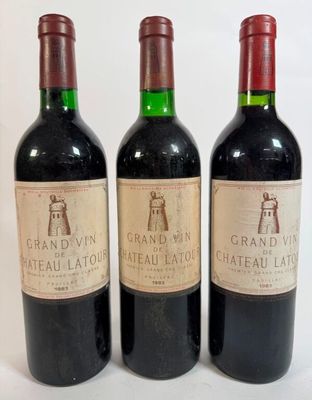 three bottles of wine are lined up on a white surface