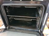a black oven with two open racks in it