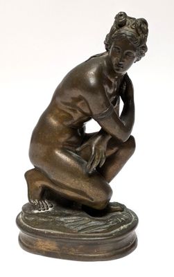 an image of a bronze statue of a man sitting on a pedestal