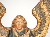 a statue of an angel with a harp on a table