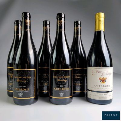 six bottles of wine are lined up on a table
