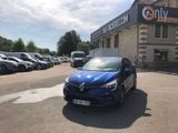 a blue car that is parked in front of a building