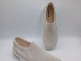 a pair of white slip on shoes on a white background