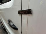 a close up of a car door handle with a sticker on it