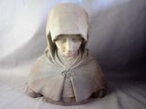 a statue of a woman with a hood on her head